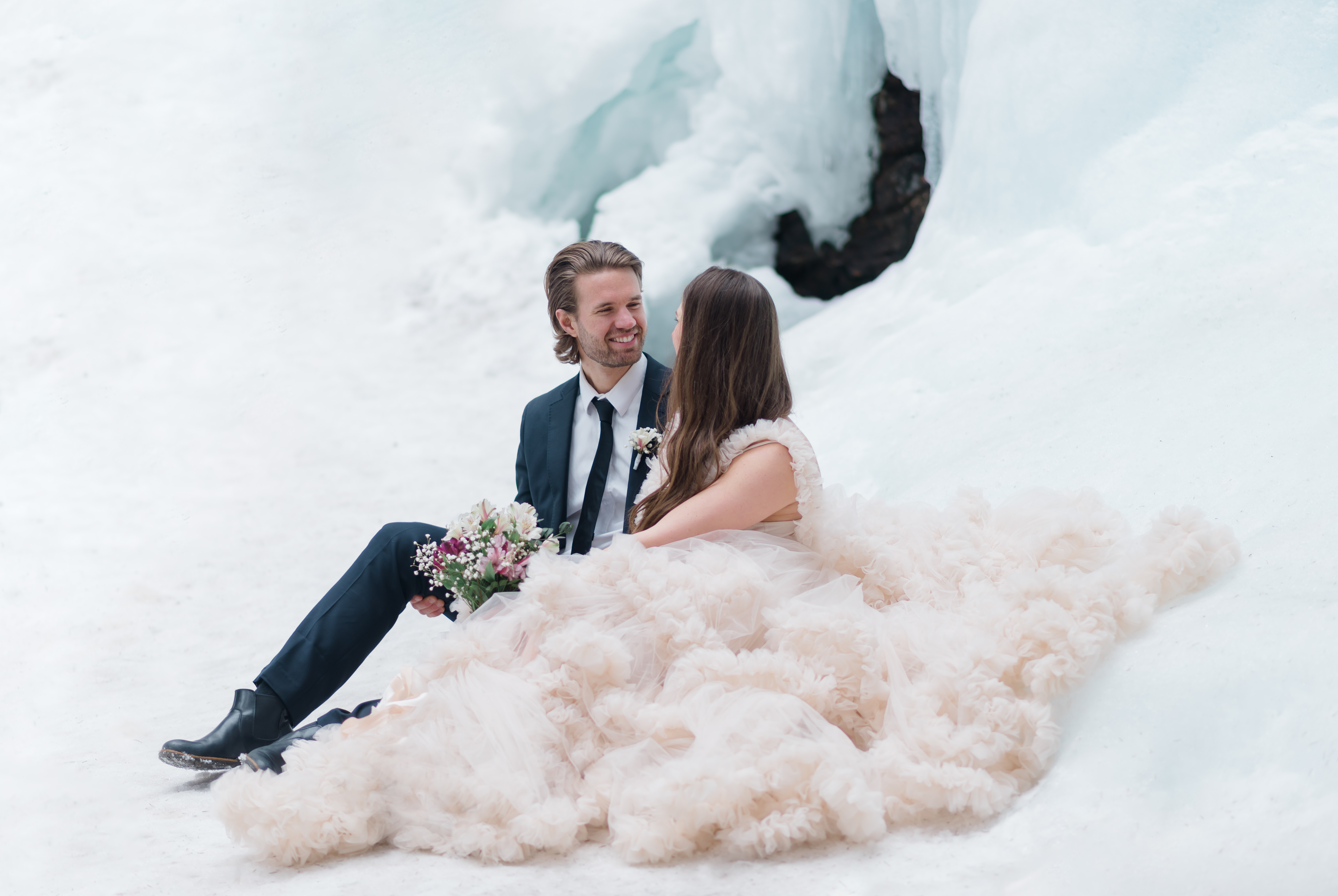 Wedding couple by a glacier wall winter wedding preshoot