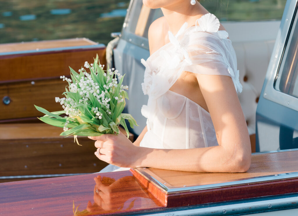 Weeding bouquet with Lily of the valley on a classic wooden boat 
